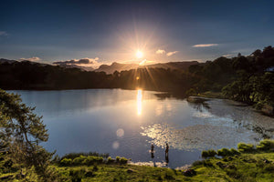 Loughrigg Tarn at sunset with two wild swimmers